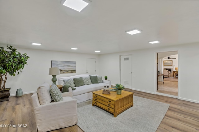 6945 N Mona Lisa Rd, Tucson, AZ 85741 - living area featuring baseboards, light wood-type flooring, and recessed lighting