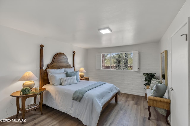 6945 N Mona Lisa Rd, Tucson, AZ 85741 - bedroom featuring wood finished floors and brick wall