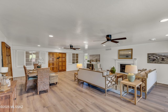 6945 N Mona Lisa Rd, Tucson, AZ 85741 - living room with ceiling fan, light wood finished floors, recessed lighting, and a fireplace