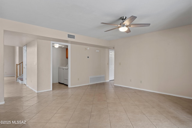 941 W Fox Ridge Ln, Oro Valley, AZ 85737 - spare room featuring ceiling fan, stairway, light tile patterned floors, washer and clothes dryer, and baseboards