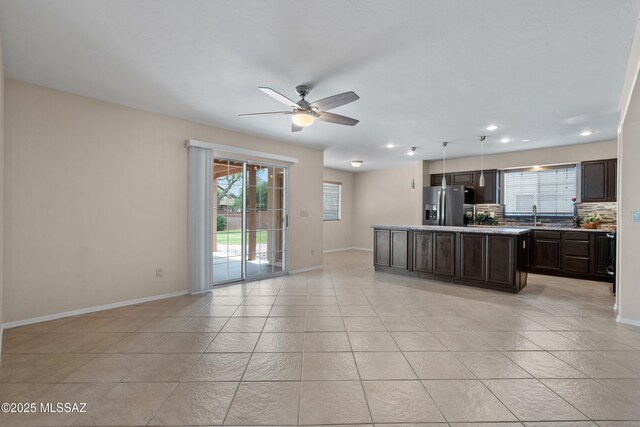 941 W Fox Ridge Ln, Oro Valley, AZ 85737 - kitchen with refrigerator with ice dispenser, healthy amount of natural light, ceiling fan, dark brown cabinetry, and recessed lighting