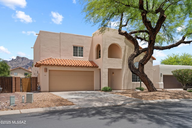 941 W Fox Ridge Ln, Oro Valley, AZ 85737 - view of front of house with driveway, stucco siding, a tiled roof, a garage, and a mountain view