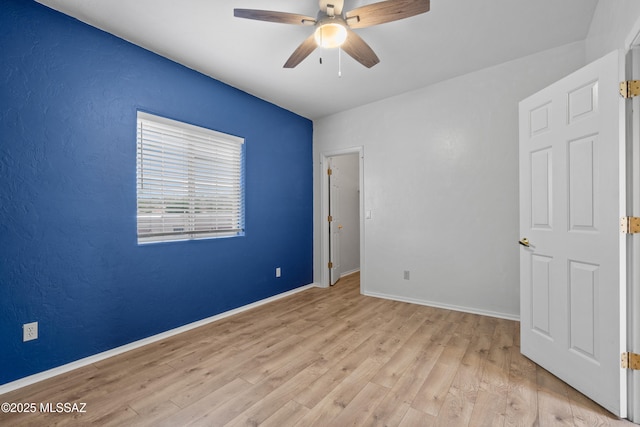 941 W Fox Ridge Ln, Oro Valley, AZ 85737 - unfurnished bedroom featuring light wood-type flooring, baseboards, and ceiling fan