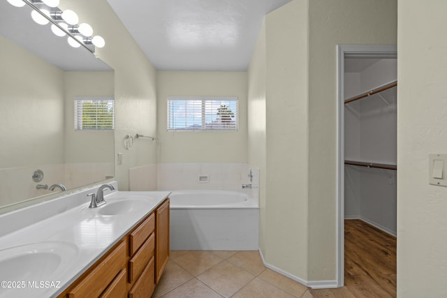 941 W Fox Ridge Ln, Oro Valley, AZ 85737 - bathroom with a garden tub, double vanity, and a walk in closet