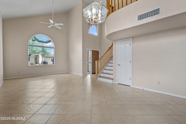 941 W Fox Ridge Ln, Oro Valley, AZ 85737 - empty room with healthy amount of natural light, a towering ceiling, stairs, ceiling fan, and baseboards