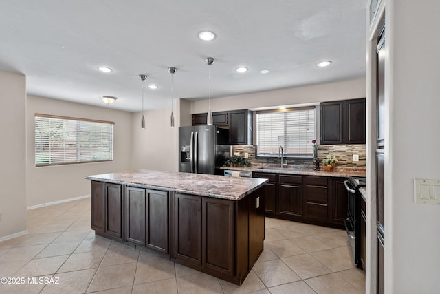 941 W Fox Ridge Ln, Oro Valley, AZ 85737 - kitchen featuring fridge with ice dispenser, a sink, electric range oven, decorative backsplash, and a kitchen island