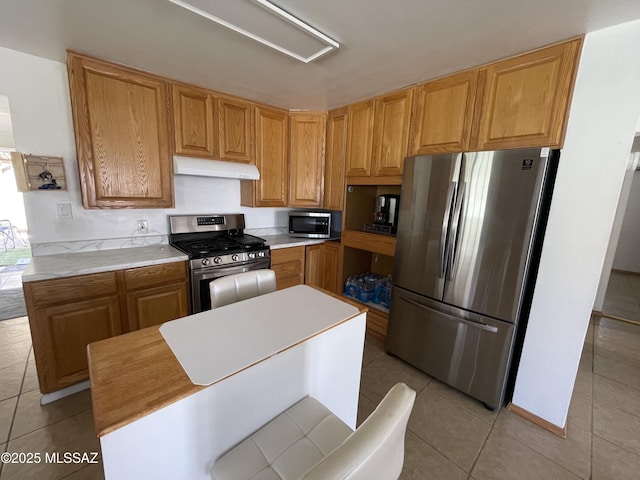 1202 E 26th St, Tucson, AZ 85713 - kitchen featuring appliances with stainless steel finishes, extractor fan, light tile patterned floors, and light countertops