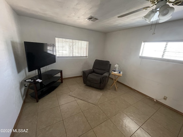 1202 E 26th St, Tucson, AZ 85713 - sitting room featuring healthy amount of natural light, ceiling fan, light tile patterned floors, and baseboards