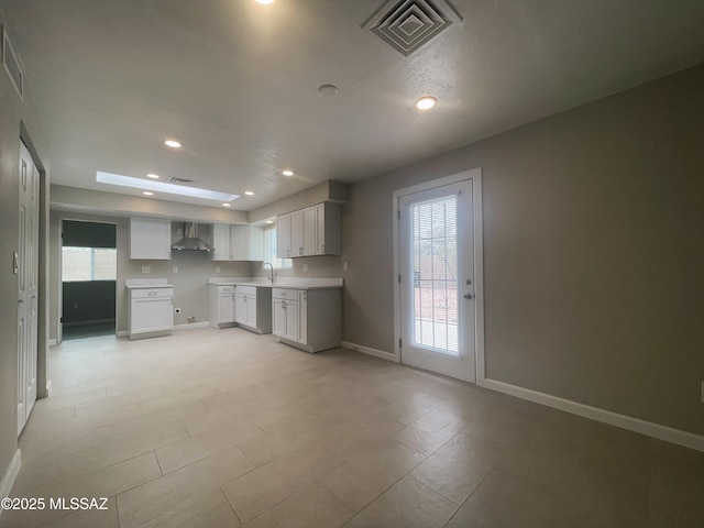 2330 N Los Altos Ave, Tucson, AZ 85705 - kitchen with a sink, wall chimney range hood, recessed lighting, baseboards, and light countertops