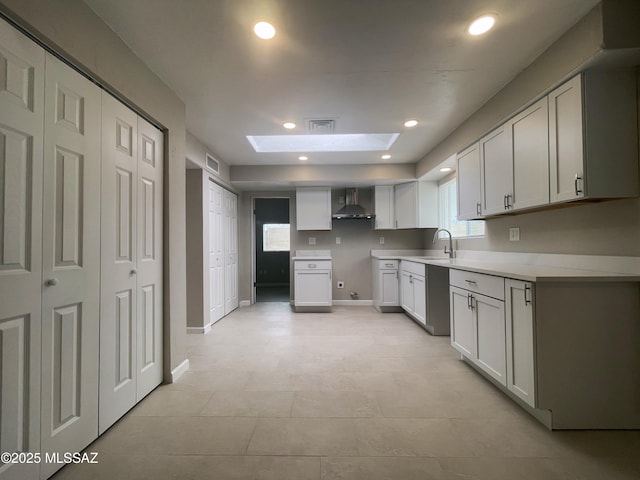 2330 N Los Altos Ave, Tucson, AZ 85705 - kitchen with a skylight, wall chimney exhaust hood, a sink, recessed lighting, and baseboards