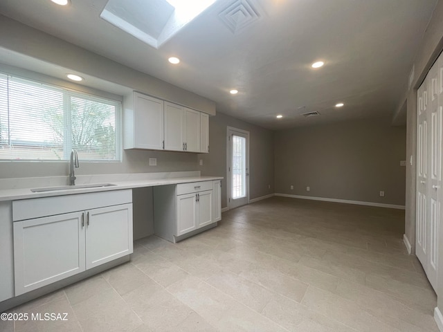 2330 N Los Altos Ave, Tucson, AZ 85705 - kitchen featuring a sink, recessed lighting, light countertops, light tile patterned floors, and baseboards