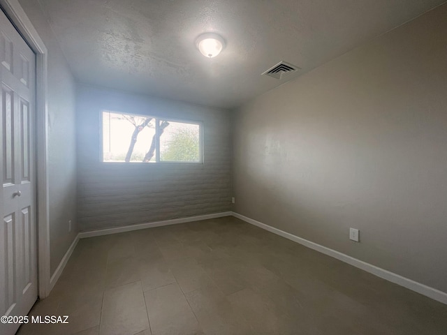 2330 N Los Altos Ave, Tucson, AZ 85705 - spare room featuring baseboards and a textured ceiling