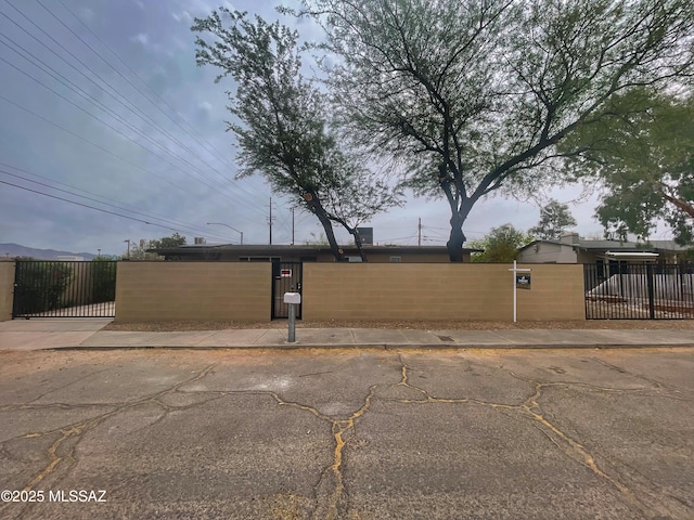 2330 N Los Altos Ave, Tucson, AZ 85705 - exterior space featuring a fenced front yard and a gate