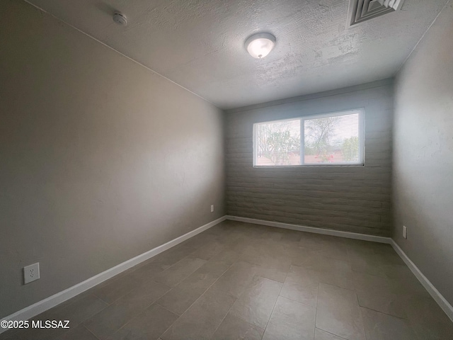 2330 N Los Altos Ave, Tucson, AZ 85705 - unfurnished room featuring a textured ceiling and baseboards