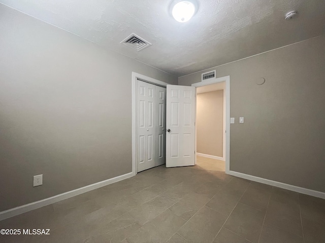 2330 N Los Altos Ave, Tucson, AZ 85705 - unfurnished bedroom featuring baseboards and a closet
