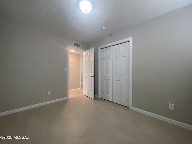 2330 N Los Altos Ave, Tucson, AZ 85705 - unfurnished bedroom featuring baseboards and a closet