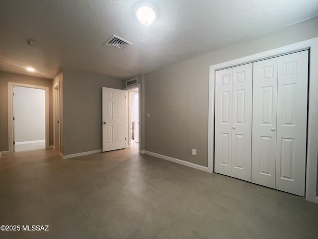 2330 N Los Altos Ave, Tucson, AZ 85705 - unfurnished bedroom featuring baseboards and a closet