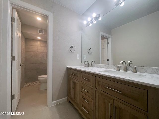 2330 N Los Altos Ave, Tucson, AZ 85705 - full bath featuring toilet, double vanity, and tile patterned floors