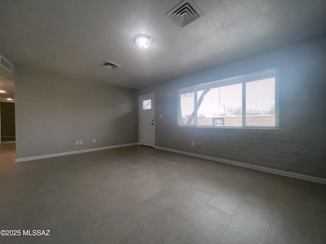 2330 N Los Altos Ave, Tucson, AZ 85705 - empty room featuring baseboards and a textured ceiling