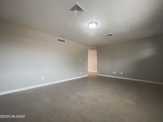 2330 N Los Altos Ave, Tucson, AZ 85705 - spare room with baseboards and a textured ceiling