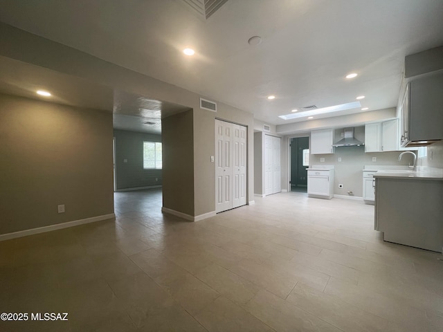 2330 N Los Altos Ave, Tucson, AZ 85705 - unfurnished living room with baseboards, a sink, and recessed lighting