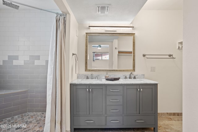 4302 E 6th St, Tucson, AZ 85711 - full bath featuring a tile shower, double vanity, and baseboards