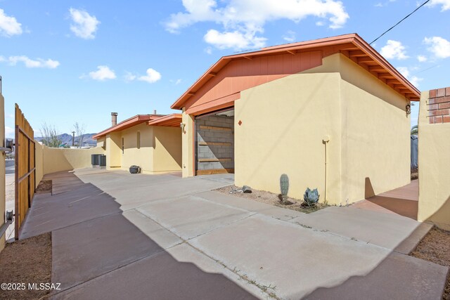 4302 E 6th St, Tucson, AZ 85711 - view of outbuilding with driveway, cooling unit, and a garage