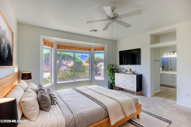 2312 E Coreopsis Way, Oro Valley, AZ 85755 - bedroom with multiple windows, light carpet, and connected bathroom