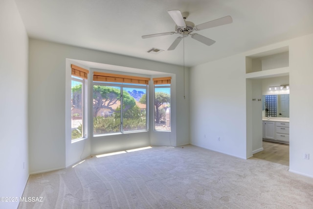 2312 E Coreopsis Way, Oro Valley, AZ 85755 - spare room with light carpet, a ceiling fan, and baseboards