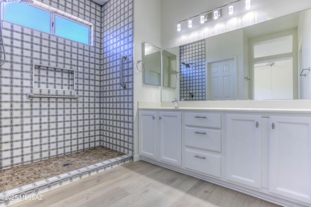 2312 E Coreopsis Way, Oro Valley, AZ 85755 - full bathroom with wood finished floors, double vanity, tiled shower, and a ceiling fan