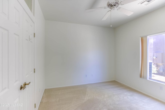 2312 E Coreopsis Way, Oro Valley, AZ 85755 - unfurnished bedroom featuring light colored carpet, a closet, ceiling fan, and baseboards