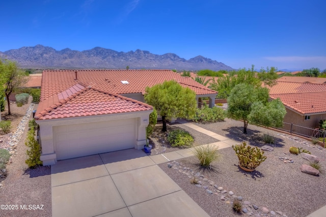 2312 E Coreopsis Way, Oro Valley, AZ 85755 - mediterranean / spanish home with driveway, stucco siding, a tiled roof, a mountain view, and an attached garage