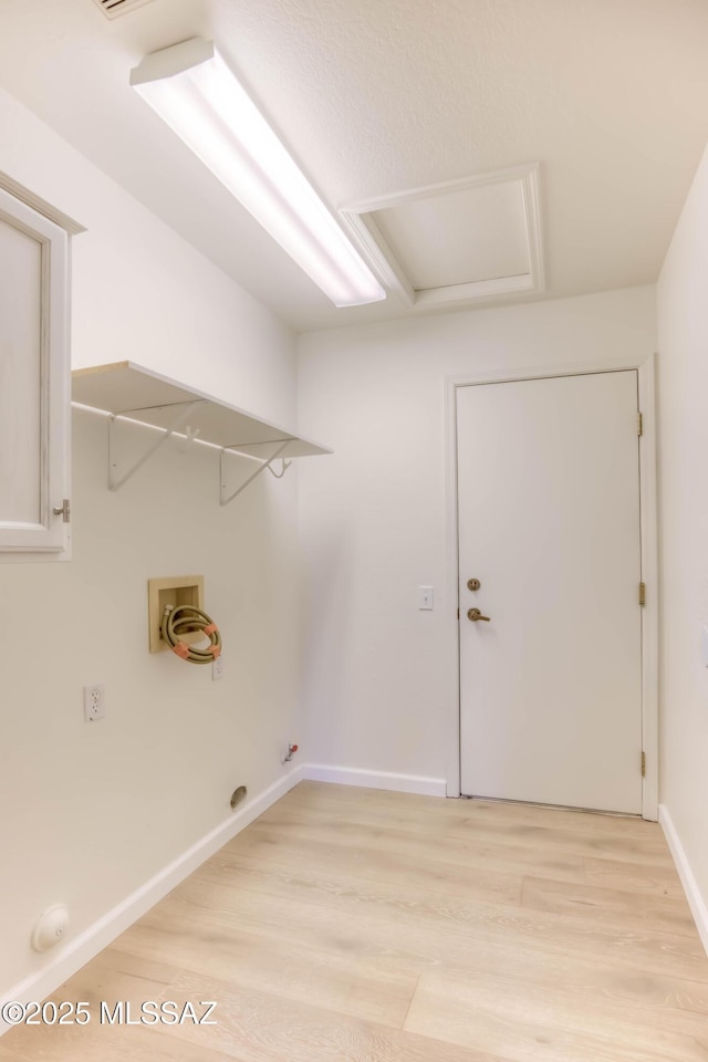 2312 E Coreopsis Way, Oro Valley, AZ 85755 - laundry room featuring attic access, light wood finished floors, washer hookup, and baseboards