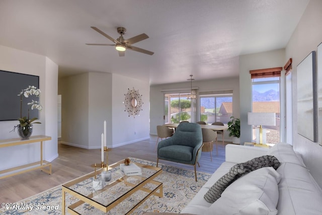 2312 E Coreopsis Way, Oro Valley, AZ 85755 - living room featuring wood finished floors, ceiling fan, and baseboards