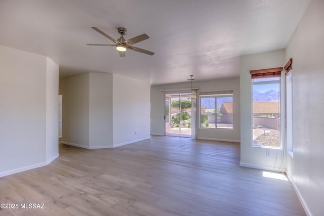 2312 E Coreopsis Way, Oro Valley, AZ 85755 - spare room featuring ceiling fan, wood finished floors, and baseboards
