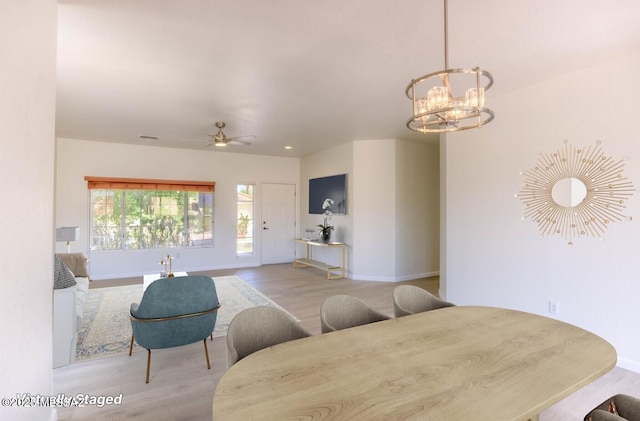 2312 E Coreopsis Way, Oro Valley, AZ 85755 - dining room featuring wood finished floors, baseboards, a chandelier, and a ceiling fan