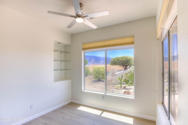 2312 E Coreopsis Way, Oro Valley, AZ 85755 - unfurnished room with baseboards, wood finished floors, and ceiling fan