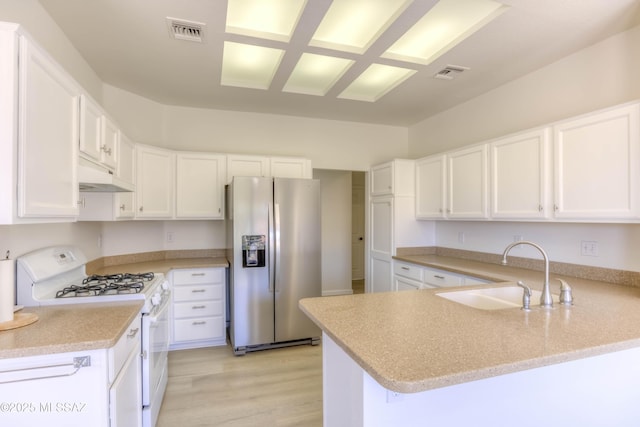 2312 E Coreopsis Way, Oro Valley, AZ 85755 - kitchen featuring stainless steel refrigerator with ice dispenser, gas range gas stove, a sink, under cabinet range hood, and a peninsula