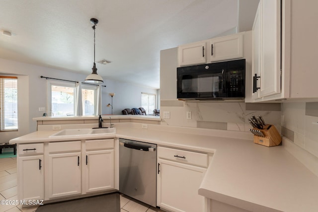 10236 E Rainbow Meadow Dr, Tucson, AZ 85747 - kitchen with stainless steel dishwasher, black microwave, a sink, a peninsula, and tasteful backsplash