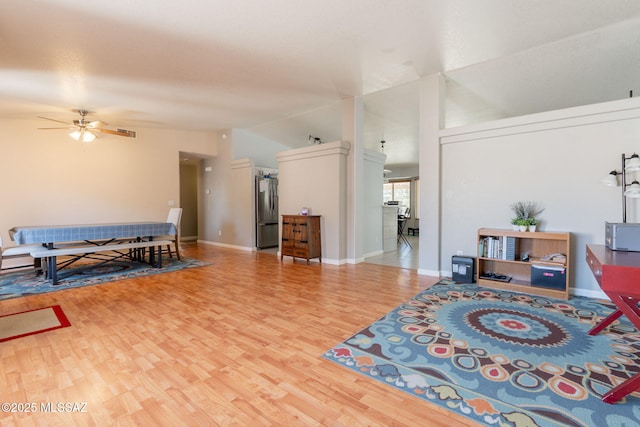 10236 E Rainbow Meadow Dr, Tucson, AZ 85747 - living room featuring wood finished floors, ceiling fan, lofted ceiling, and baseboards