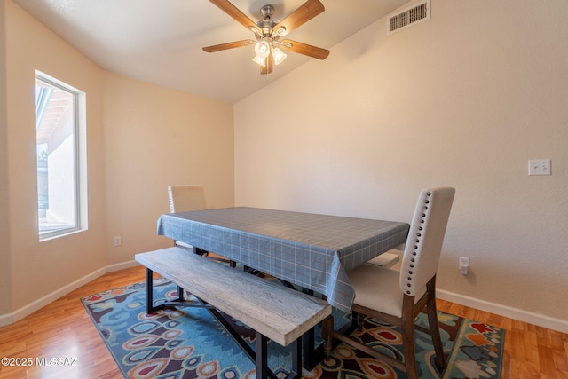 10236 E Rainbow Meadow Dr, Tucson, AZ 85747 - dining area with light wood-style flooring, baseboards, ceiling fan, and lofted ceiling