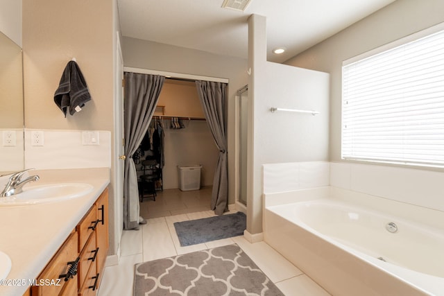 10236 E Rainbow Meadow Dr, Tucson, AZ 85747 - full bath featuring double vanity, a spacious closet, tile patterned floors, and a bath