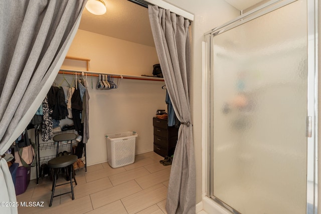 10236 E Rainbow Meadow Dr, Tucson, AZ 85747 - bathroom featuring a shower stall and a walk in closet