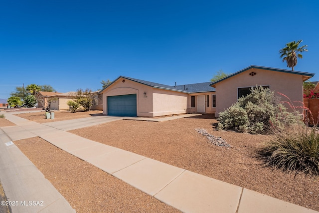 10236 E Rainbow Meadow Dr, Tucson, AZ 85747 - single story home with stucco siding, concrete driveway, an attached garage, and a shingled roof