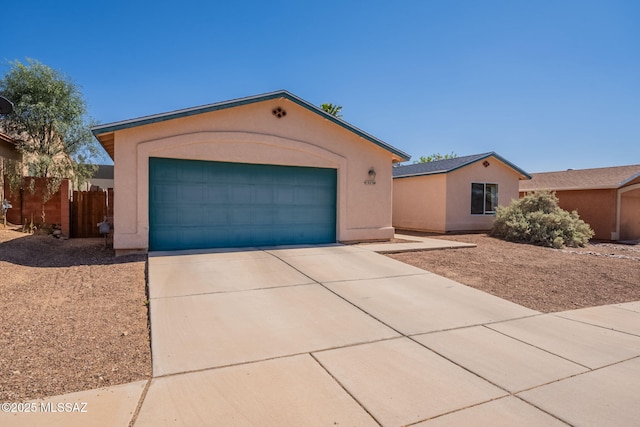 10236 E Rainbow Meadow Dr, Tucson, AZ 85747 - ranch-style house with stucco siding, concrete driveway, and a garage