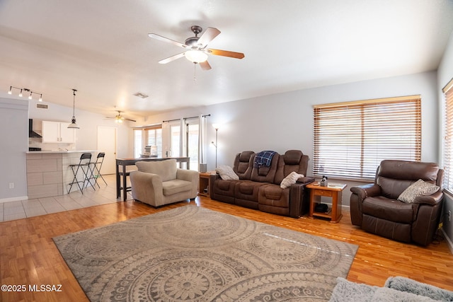 10236 E Rainbow Meadow Dr, Tucson, AZ 85747 - living area featuring a ceiling fan, light wood-style floors, and lofted ceiling