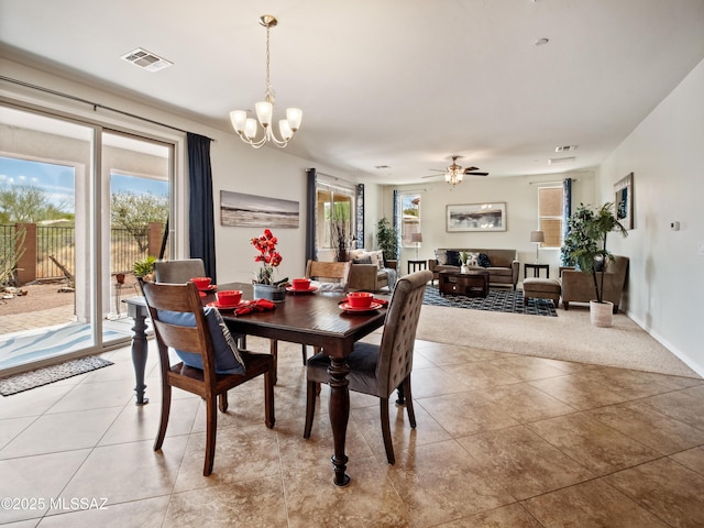 741 S Desert Haven Rd, Vail, AZ 85641 - dining area featuring light tile patterned flooring, a chandelier, light carpet, and a ceiling fan