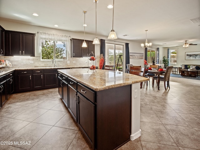 741 S Desert Haven Rd, Vail, AZ 85641 - kitchen featuring healthy amount of natural light, backsplash, light stone countertops, and recessed lighting