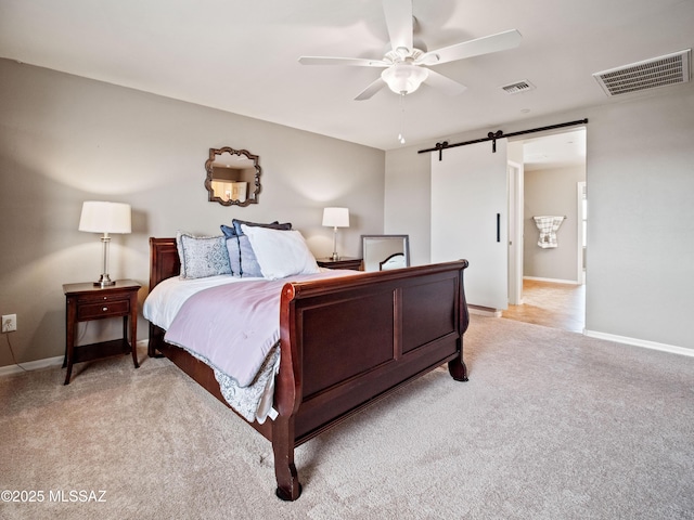 741 S Desert Haven Rd, Vail, AZ 85641 - bedroom featuring a barn door, light colored carpet, baseboards, and ceiling fan