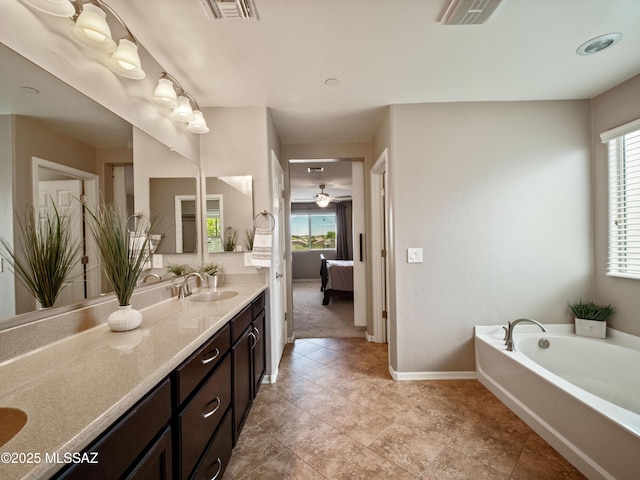 741 S Desert Haven Rd, Vail, AZ 85641 - ensuite bathroom with vanity, a garden tub, baseboards, and tile patterned flooring
